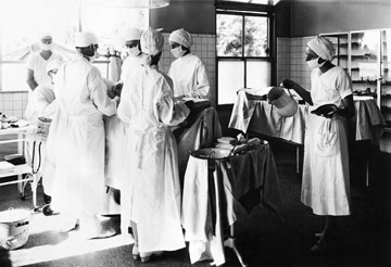 A medical team performs surgery, circa 1930s.